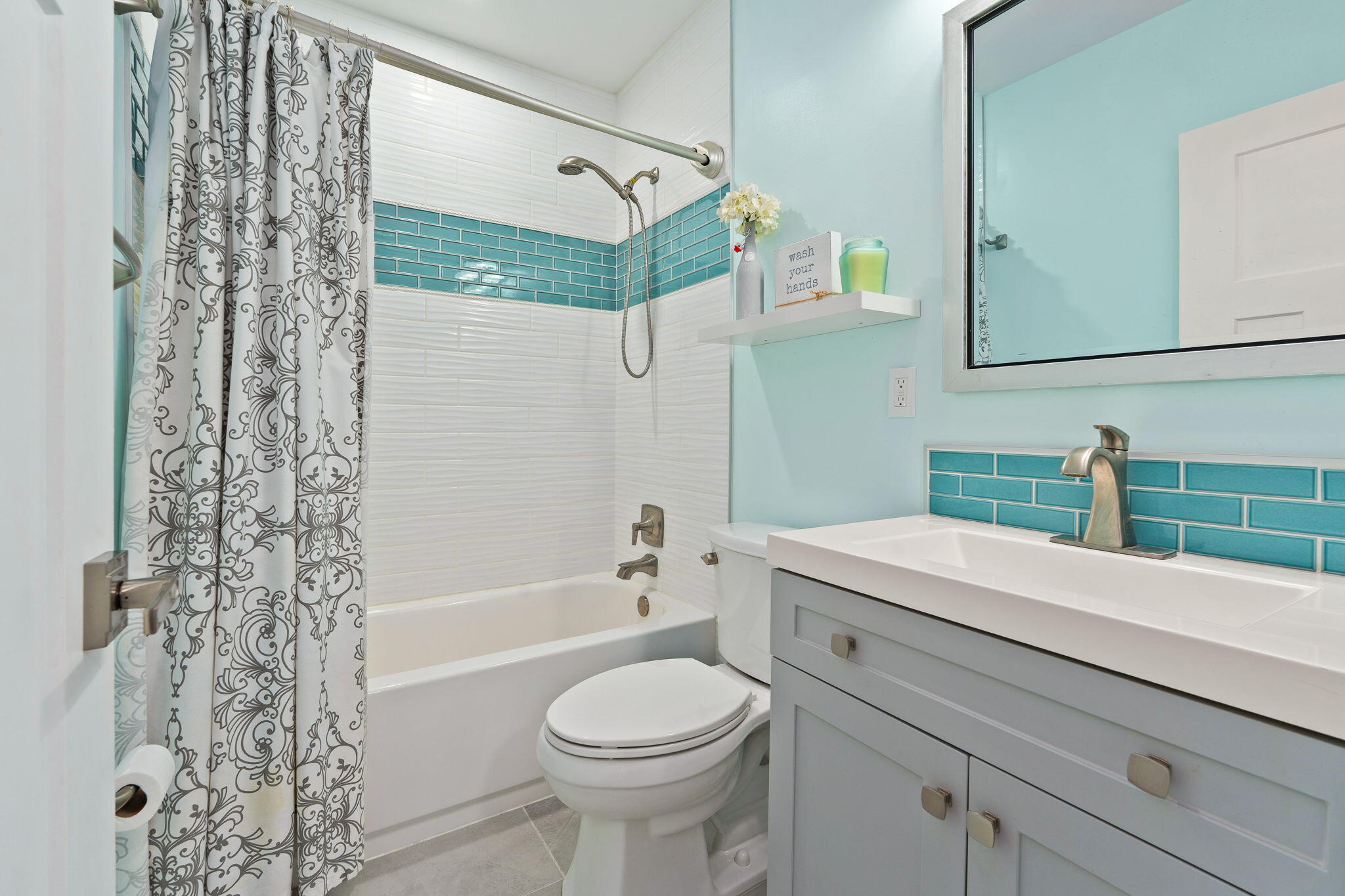 819 Southeast Stypmann Boulevard Stuart, FL 34994 - Photo 17 of 31 a bathroom with a sink a toilet and shower