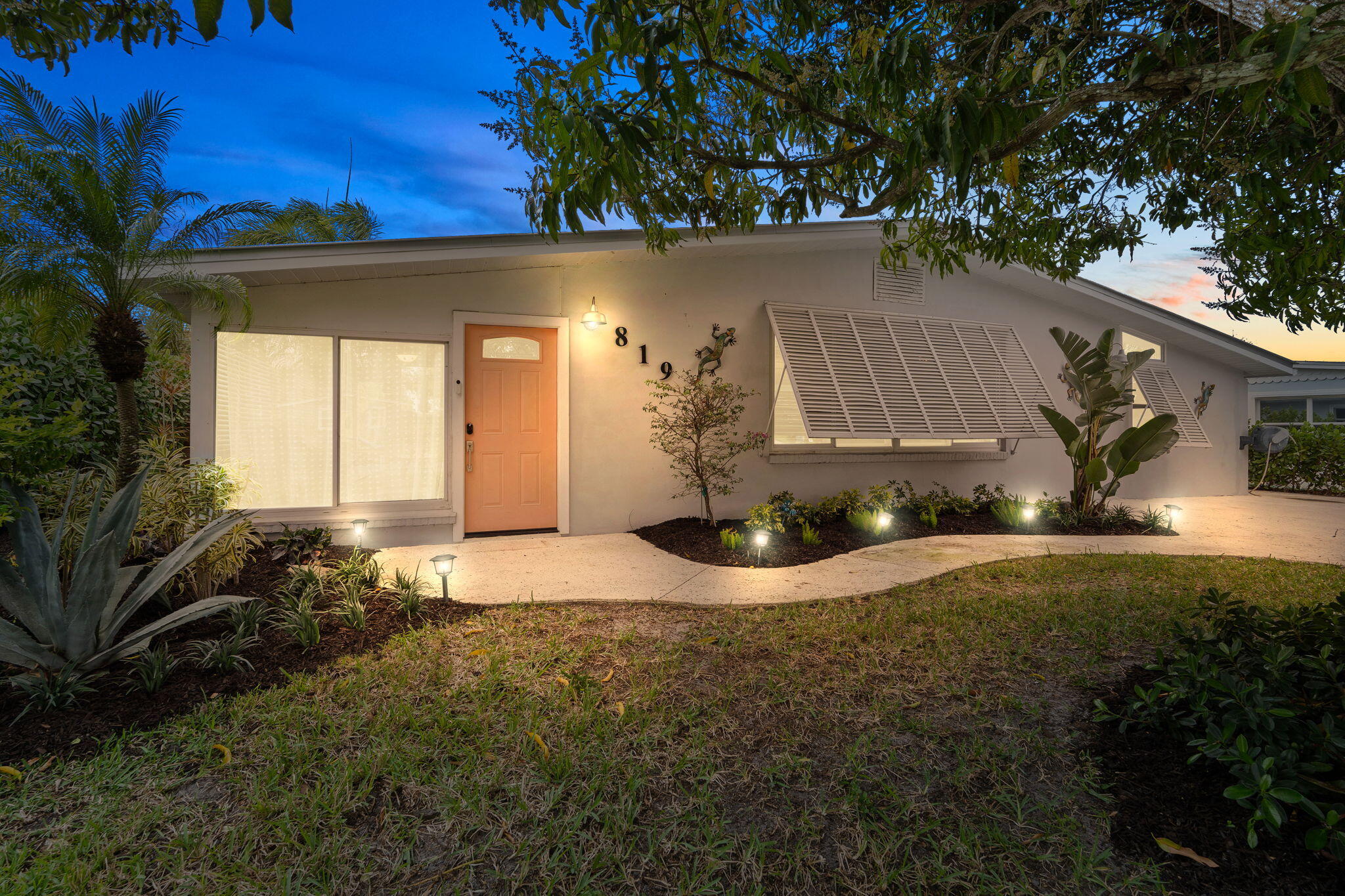 819 Southeast Stypmann Boulevard Stuart, FL 34994 - Photo 2 of 31 a house with trees in front of it