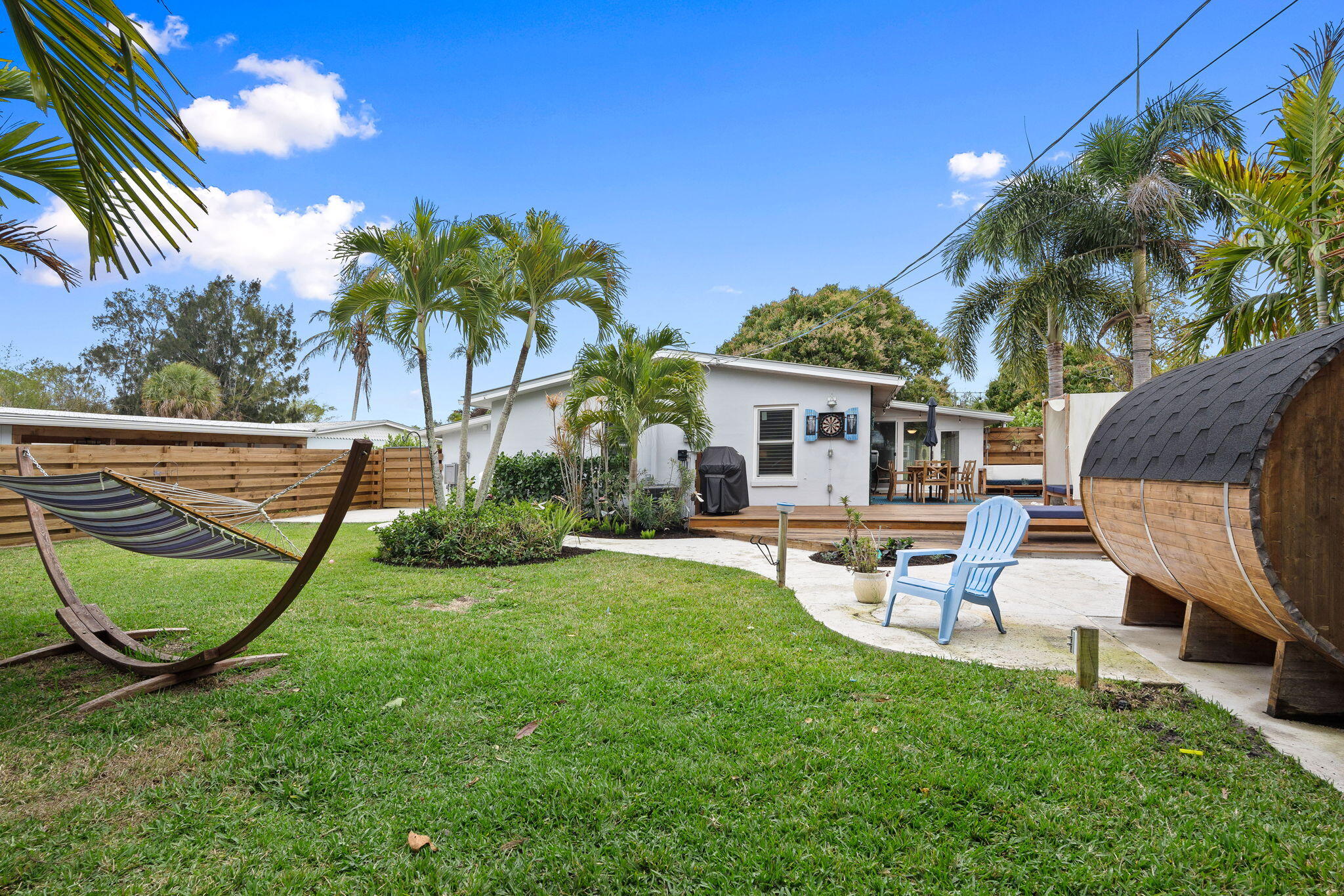 819 Southeast Stypmann Boulevard Stuart, FL 34994 - Photo 23 of 31 a view of a house with backyard porch and sitting area