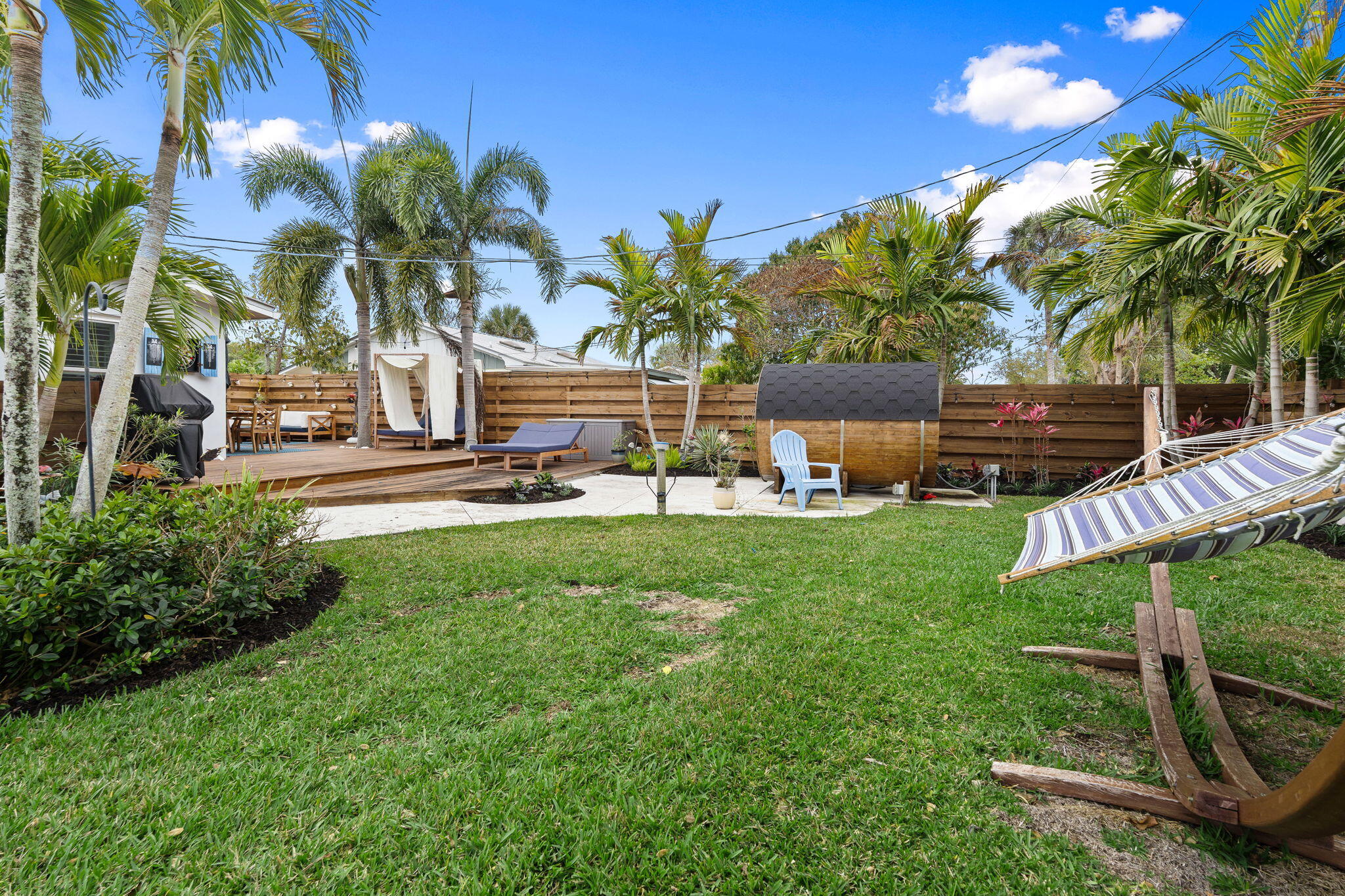 819 Southeast Stypmann Boulevard Stuart, FL 34994 - Photo 24 of 31 a view of a yard with plants and palm trees