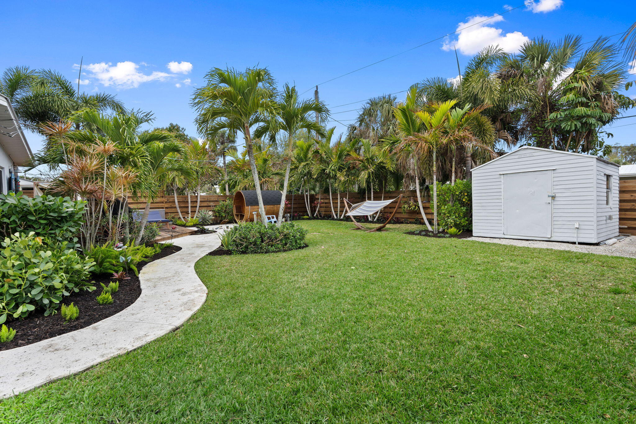 819 Southeast Stypmann Boulevard Stuart, FL 34994 - Photo 25 of 31 a view of a backyard with a garden