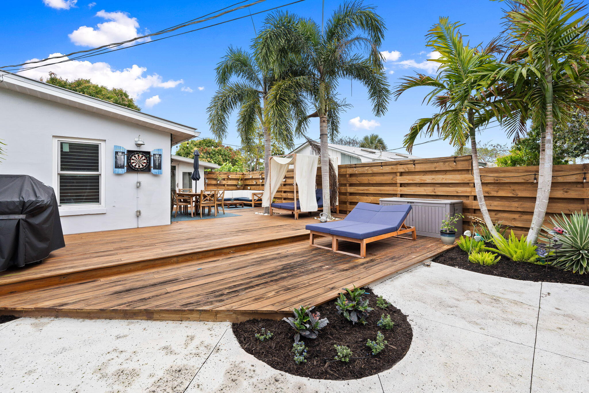 819 Southeast Stypmann Boulevard Stuart, FL 34994 - Photo 27 of 31 a view of a backyard with plants and a patio