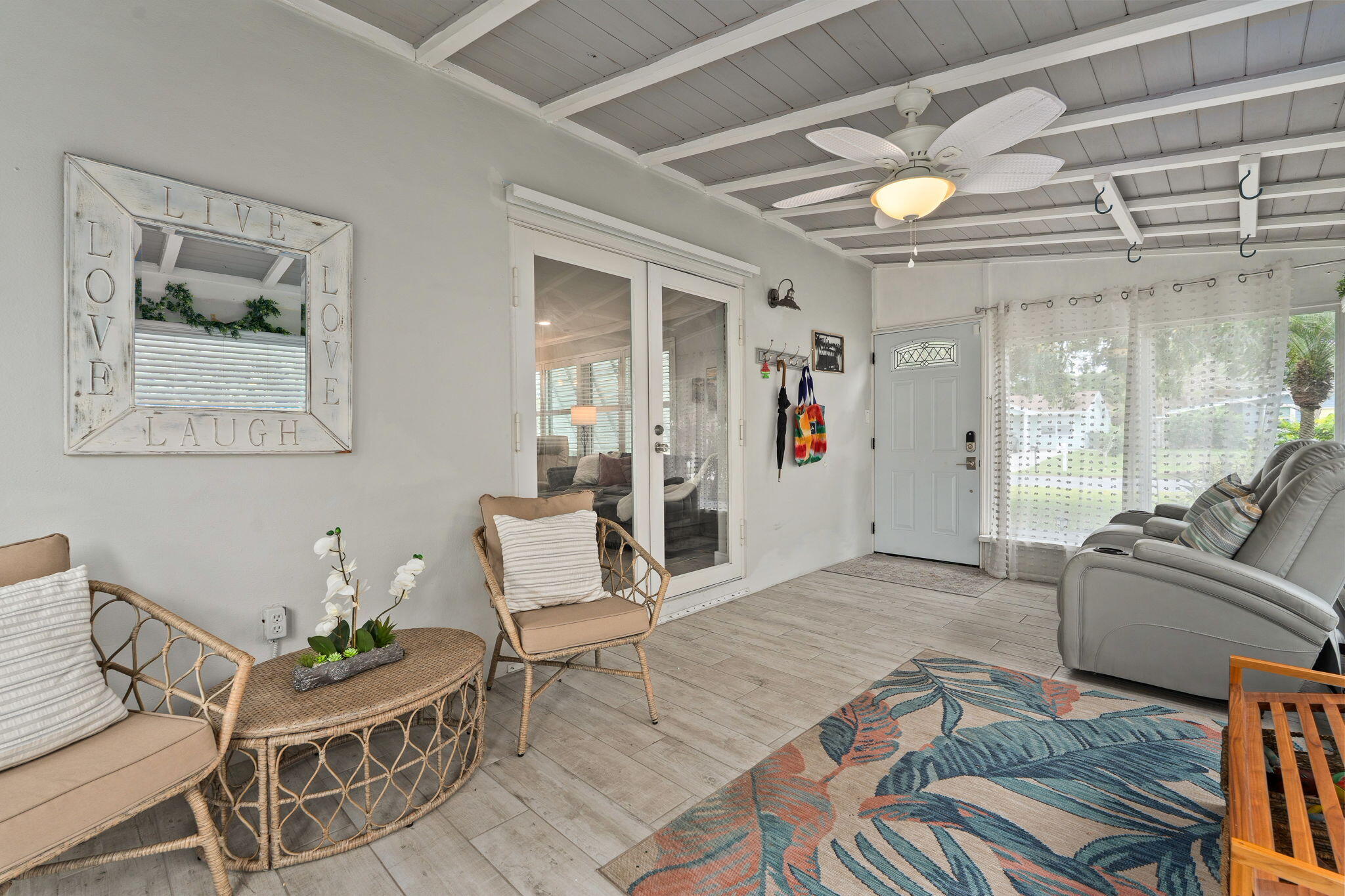 819 Southeast Stypmann Boulevard Stuart, FL 34994 - Photo 3 of 31 a living room with furniture and a chandelier