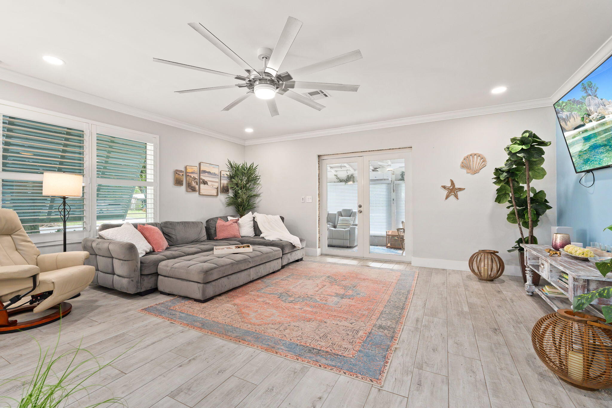 819 Southeast Stypmann Boulevard Stuart, FL 34994 - Photo 5 of 31 a living room with furniture a window and a wooden floor