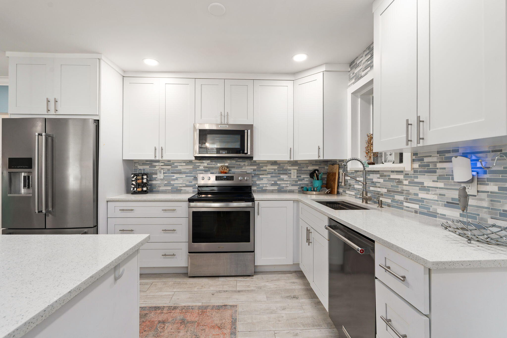 819 Southeast Stypmann Boulevard Stuart, FL 34994 - Photo 9 of 31 a kitchen with stainless steel appliances a stove sink microwave and refrigerator