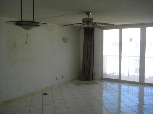 a kitchen with a refrigerator and cabinets