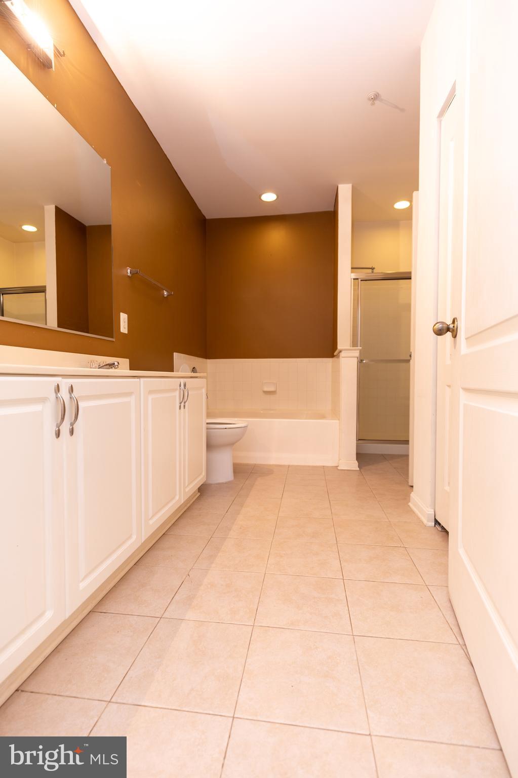 400 Symphony Circle, Unit 418H Cockeysville, MD 21030 - Photo 14 of 17 a view of a bathroom with a tub and shower