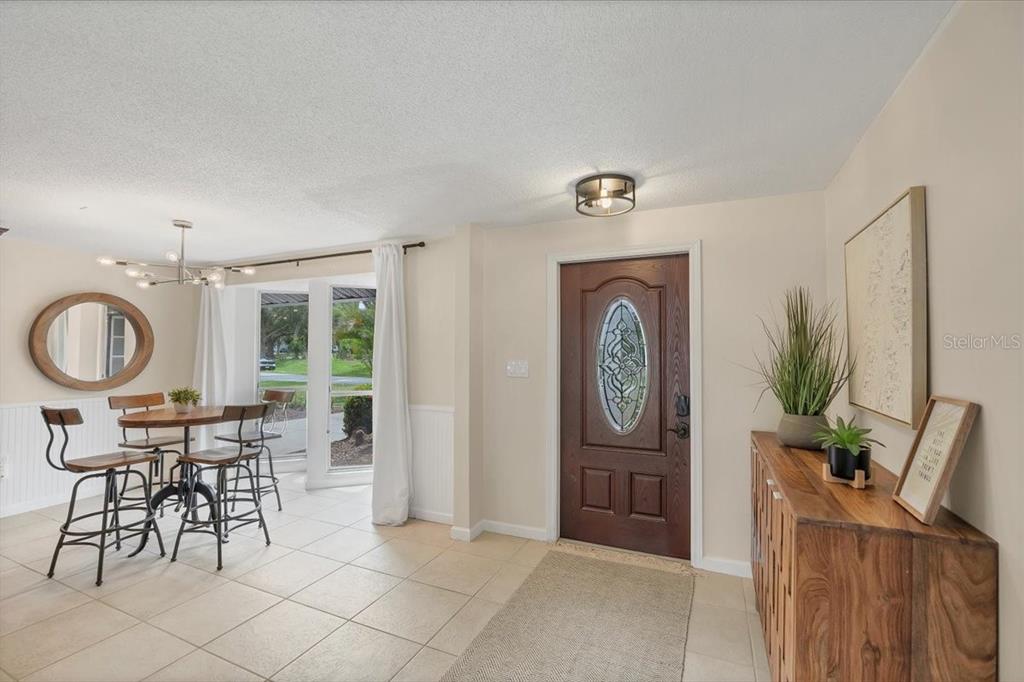 4696 Pompano Street Placida, FL 33946 - Photo 17 of 23 a view of a a dining room with furniture window and wooden floor