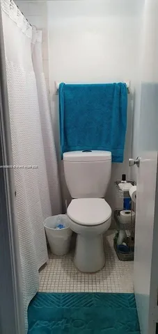 a white toilet sitting next to a small bathroom