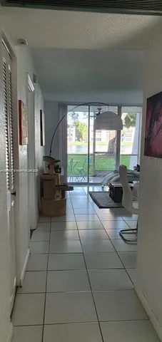 a lobby with furniture and floor to ceiling window