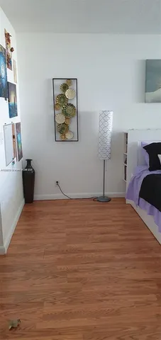 a view of a room with wooden floor and cabinet