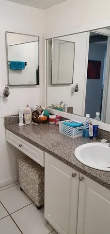 a bathroom with sink and mirror