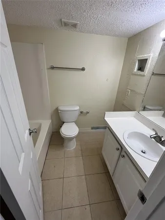 a bathroom with a sink a toilet and bathtub