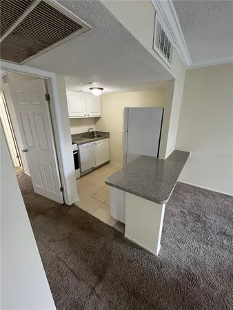 a view of a kitchen with a sink a microwave and a stove
