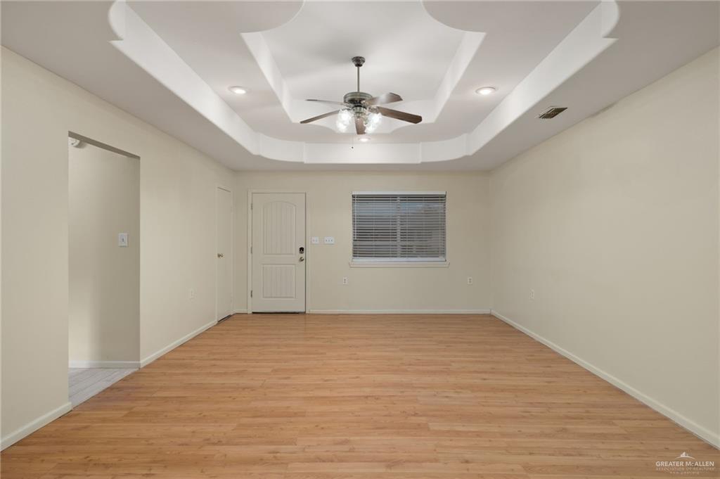 300 North 41st Street McAllen, TX 78501 - Photo 2 of 13 wooden floor in an empty room with a window