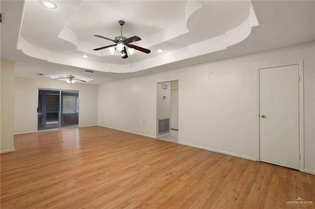 300 North 41st Street McAllen, TX 78501 - Photo 3 of 13 wooden floor in an empty room with a window