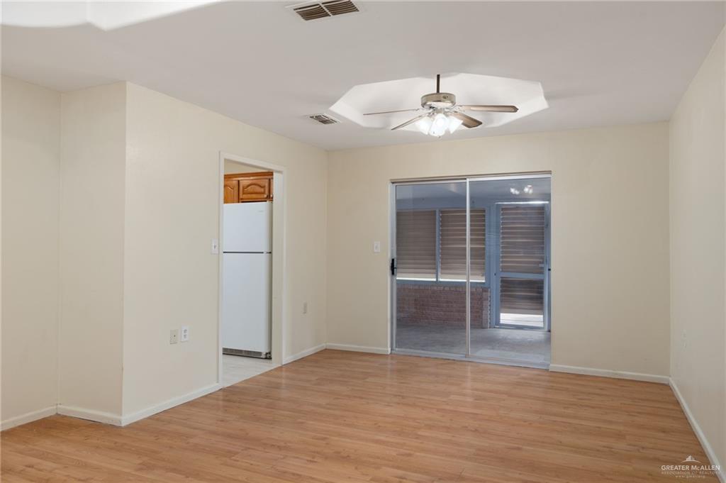 300 North 41st Street McAllen, TX 78501 - Photo 4 of 13 wooden floor in an empty room with a chandelier fan