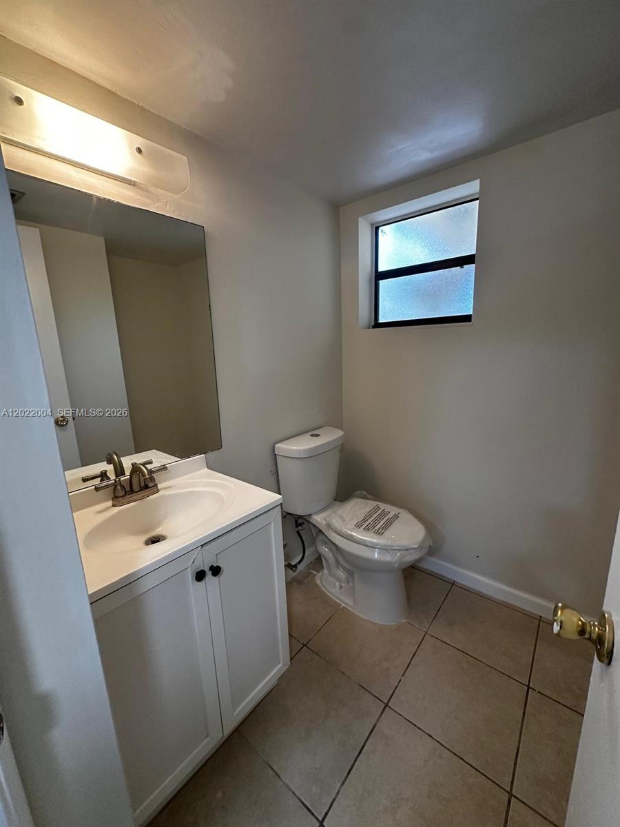 3400 Foxcroft Road, Unit 301 Miramar, FL 33025 - Photo 22 of 72 a bathroom with a toilet sink and mirror