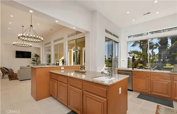 a dining room with furniture and a floor to ceiling window