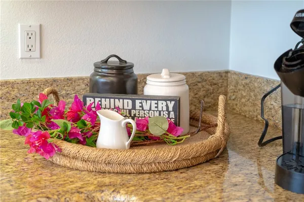 a vase of flowers sitting on a table with a vase