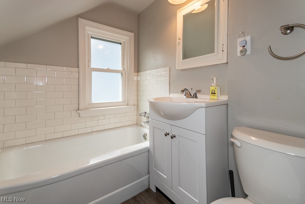 2419 Kingston Road Cleveland, OH 44118 - Photo 26 of 34 2nd floor bathroom with hardwood floors, vanity, mirror, and tile walls
