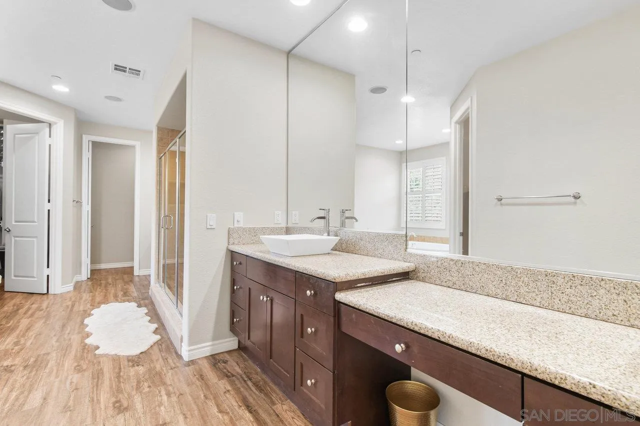 2957 Ranch Gate Road Chula Vista, CA 91914 - Photo 38 of 75 a bathroom with a sink a vanity and a large mirror