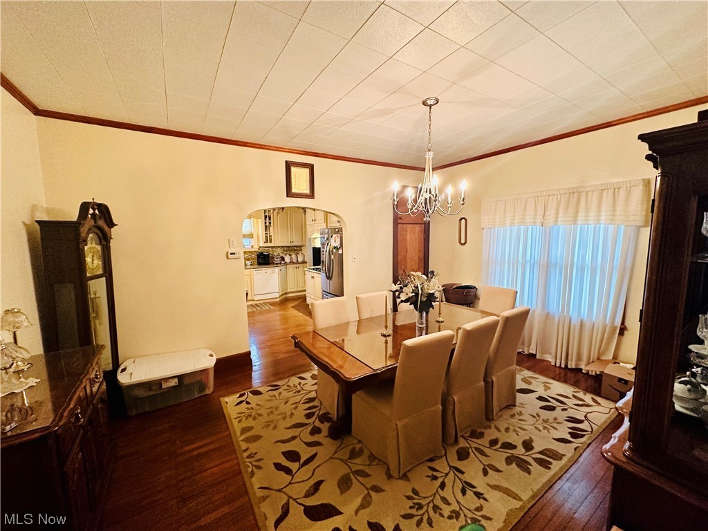 351 Rockdale Road Follansbee, WV 26037 - Photo 13 of 18 Dining space featuring crown molding, a chandelier, and hardwood / wood-style floors