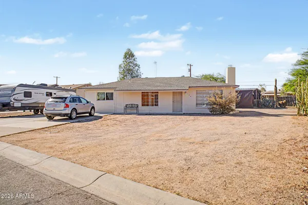 a front view of a house with cars parked