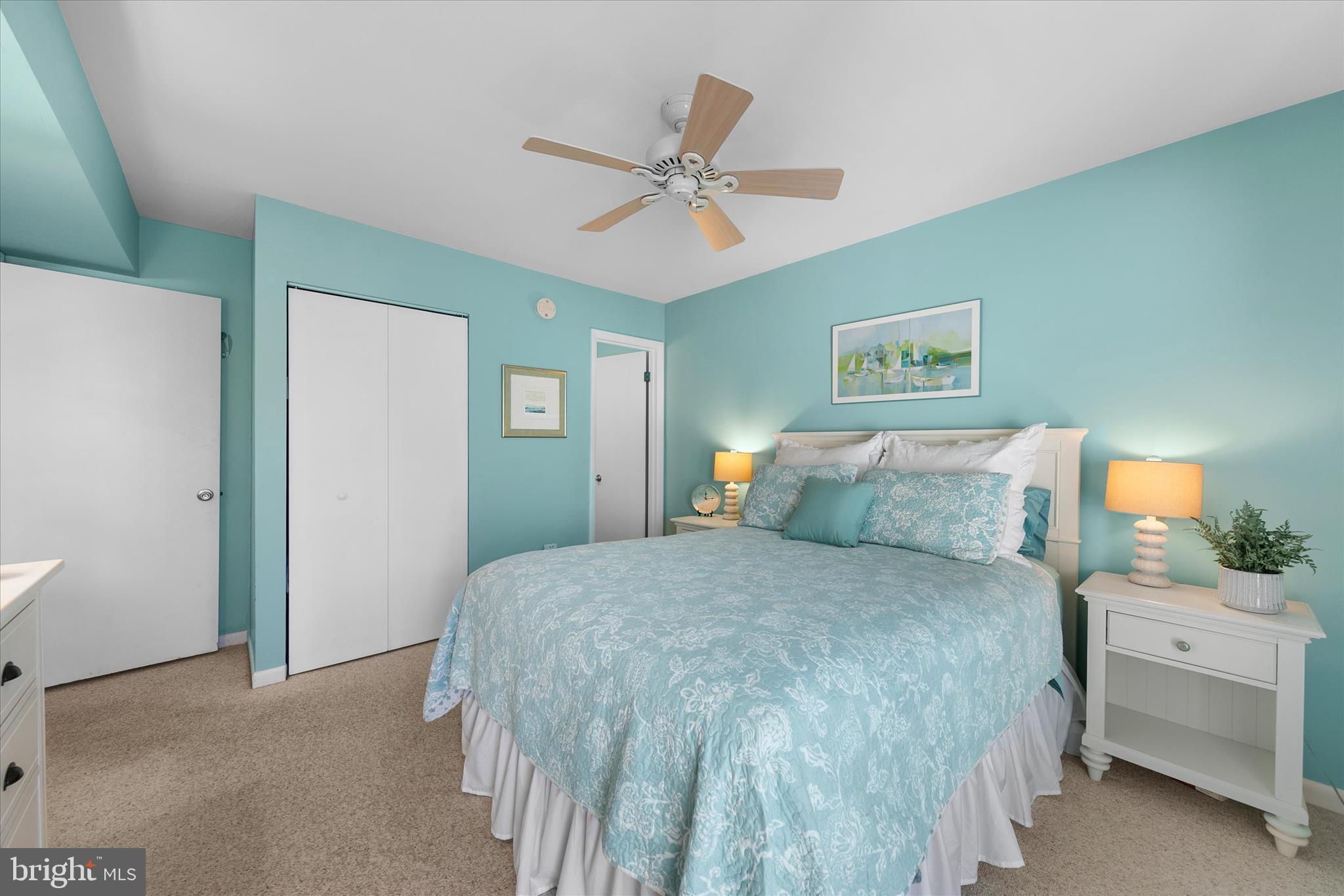 39362 Racquet Lane, Unit 8605 Bethany Beach, DE 19930 - Photo 12 of 53 a bedroom with a bed and a chandelier
