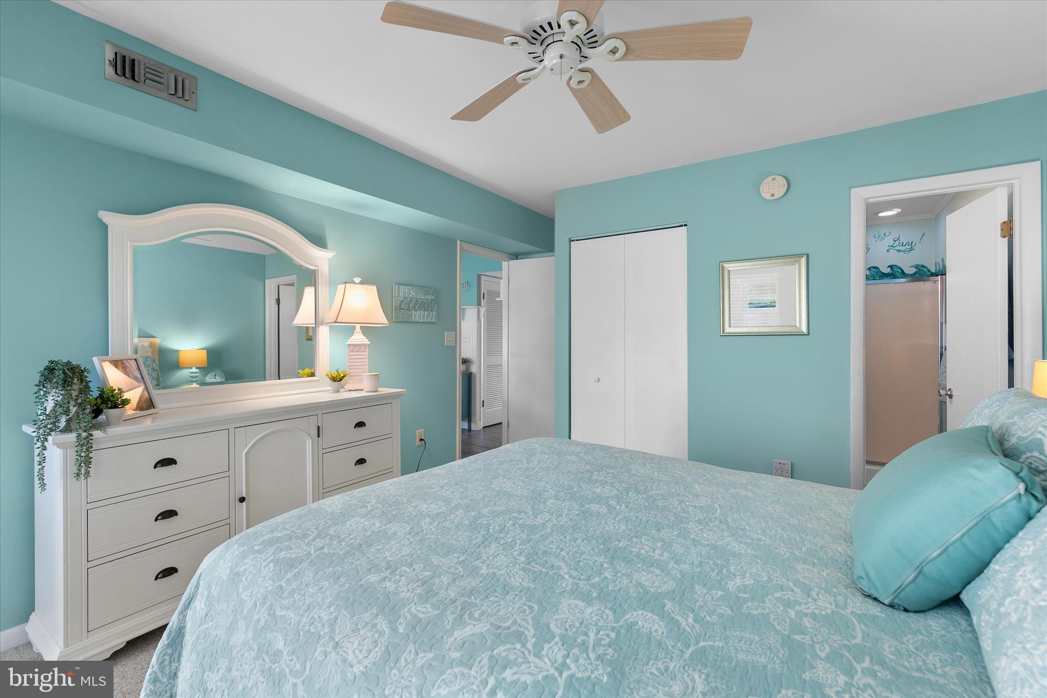 39362 Racquet Lane, Unit 8605 Bethany Beach, DE 19930 - Photo 13 of 53 a bedroom with a large bed and a chandelier