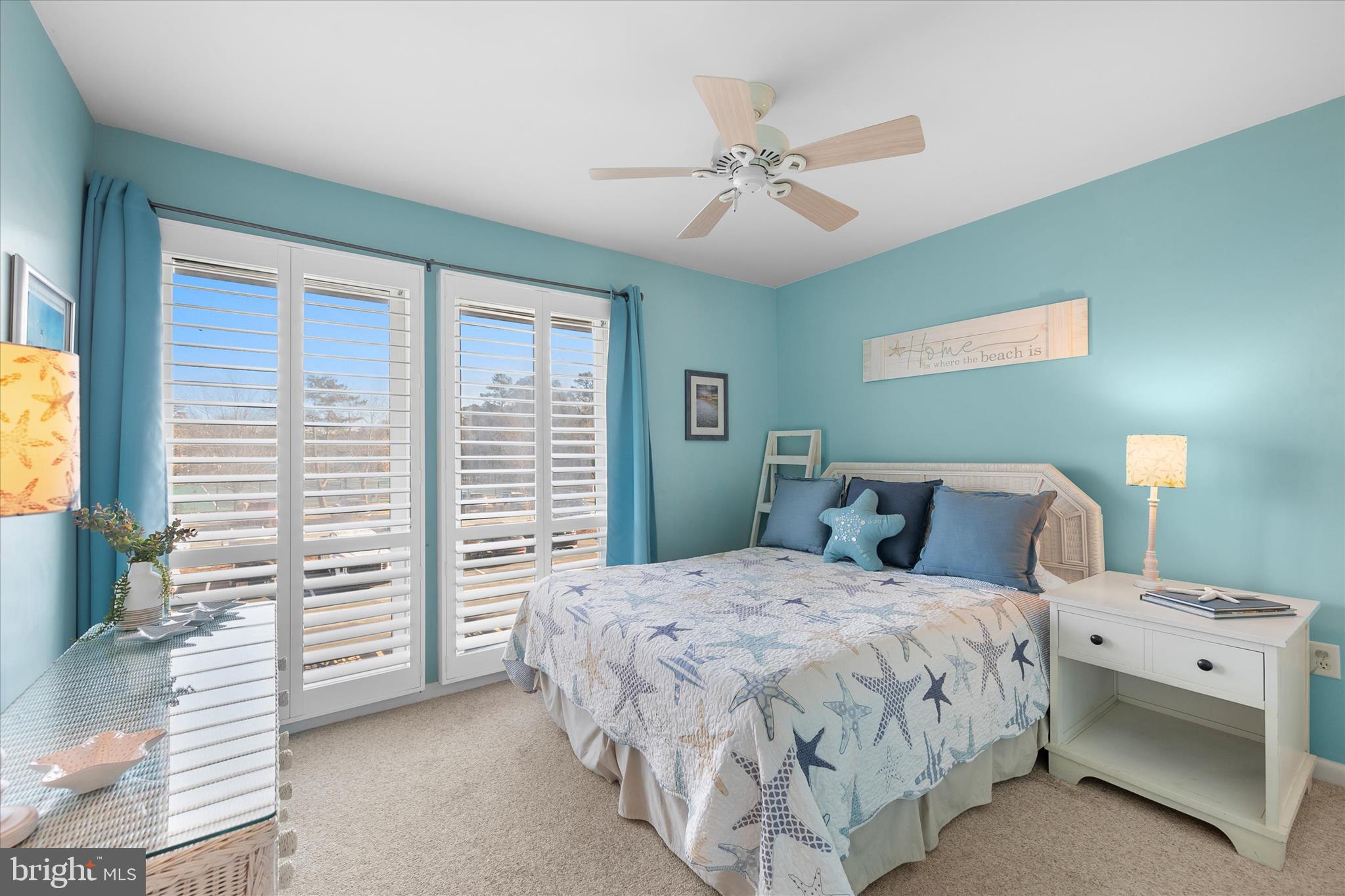 39362 Racquet Lane, Unit 8605 Bethany Beach, DE 19930 - Photo 16 of 53 a bedroom with a bed and a chandelier
