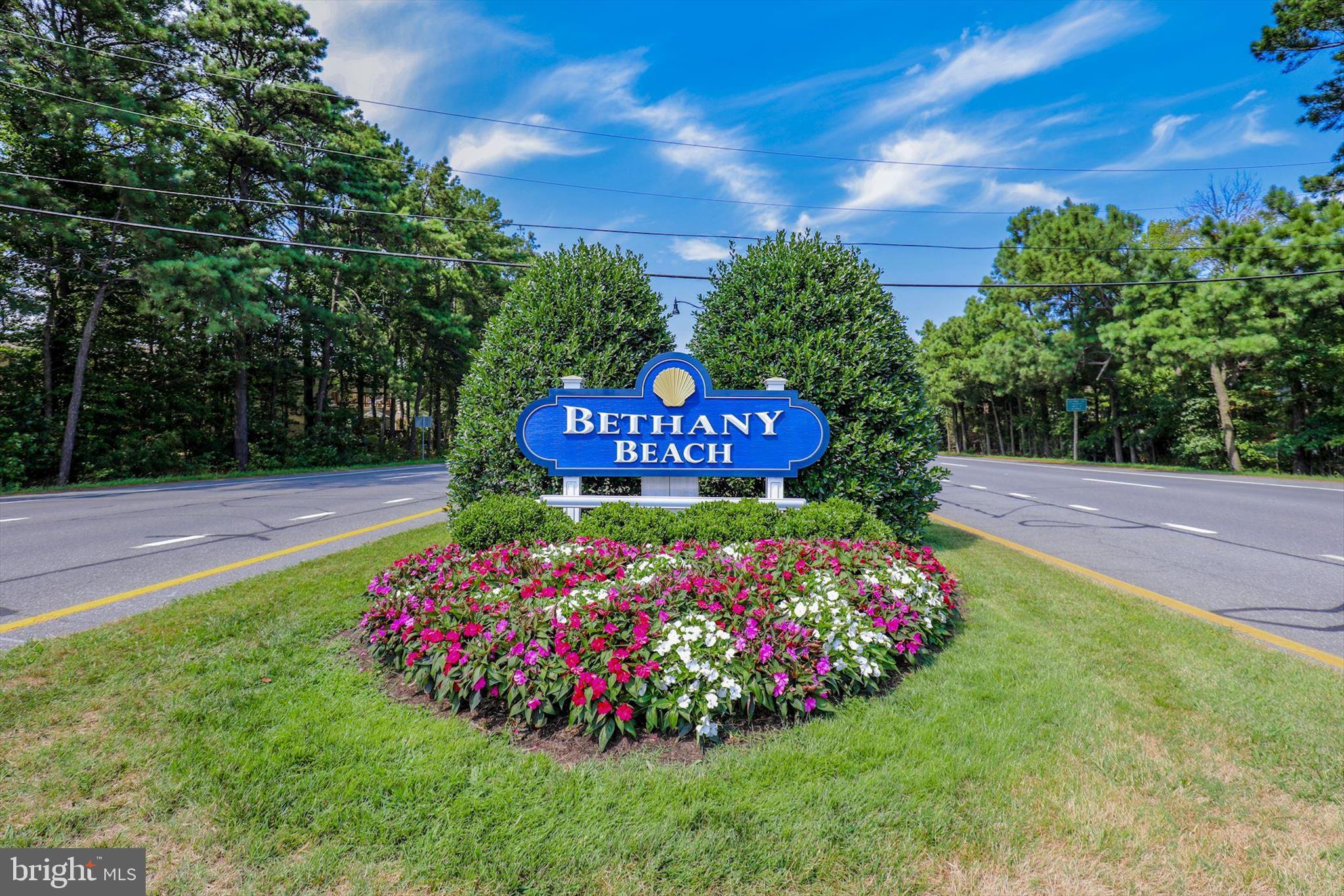 39362 Racquet Lane, Unit 8605 Bethany Beach, DE 19930 - Photo 47 of 53 a view of a garden with flowers and tree