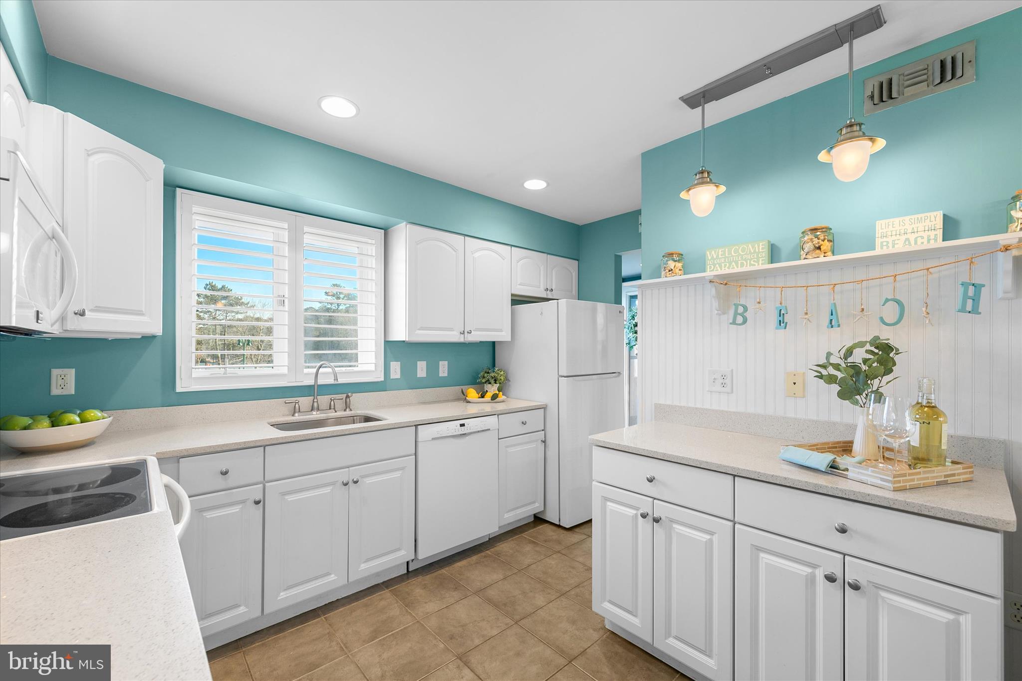 39362 Racquet Lane, Unit 8605 Bethany Beach, DE 19930 - Photo 5 of 53 a kitchen with white cabinets and sink