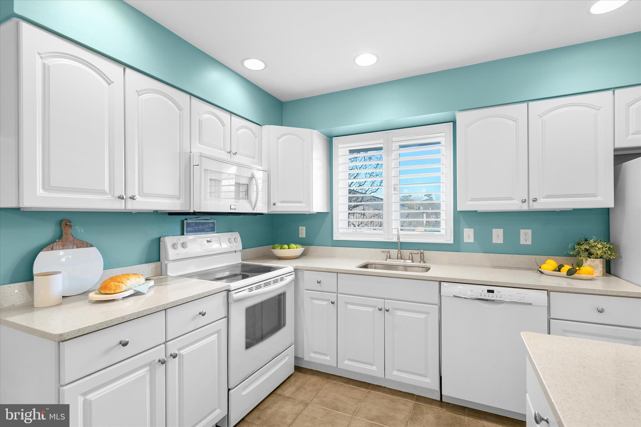 39362 Racquet Lane, Unit 8605 Bethany Beach, DE 19930 - Photo 6 of 53 a kitchen with a sink cabinets and window
