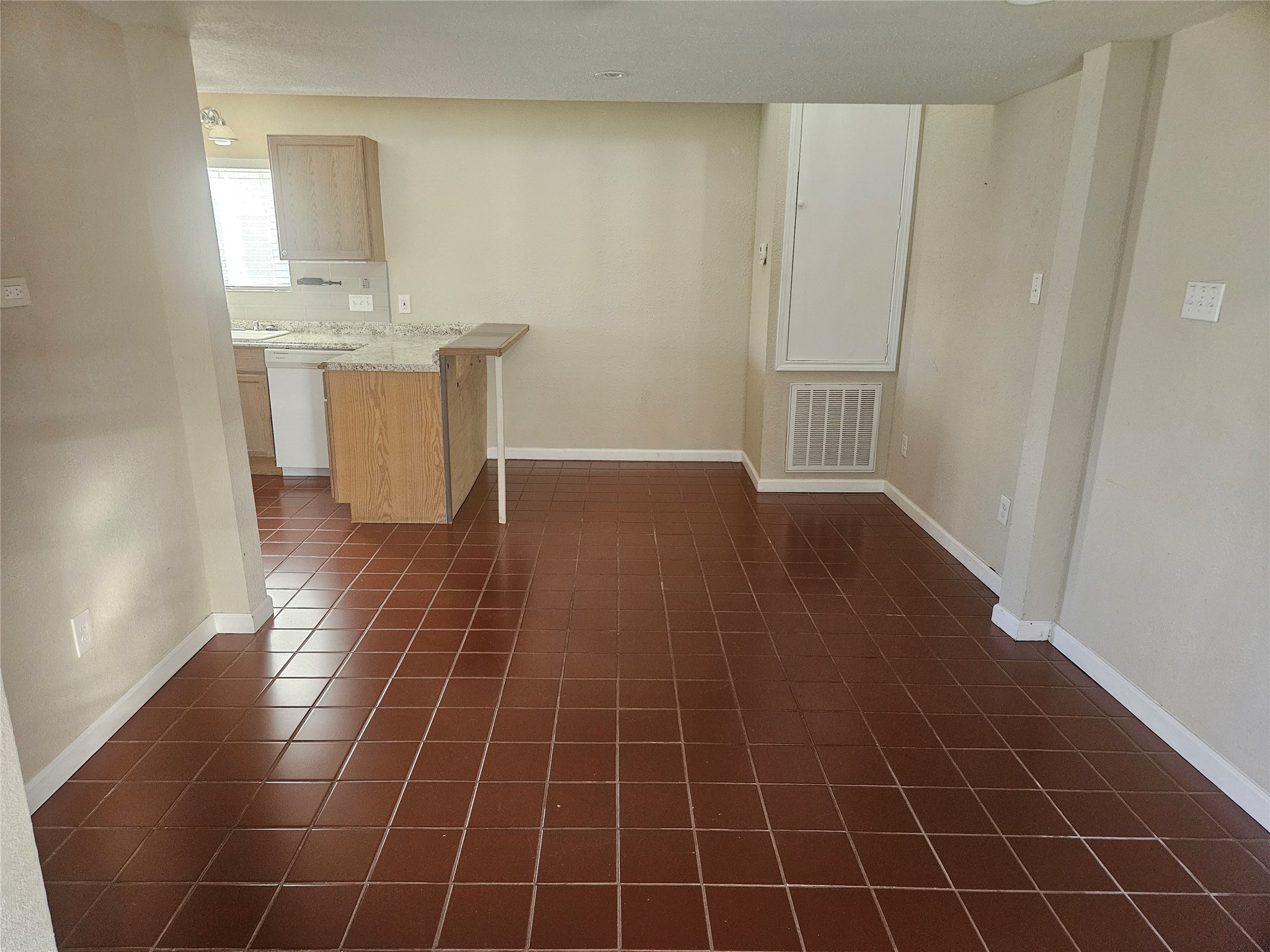 627 East 14th Street Houston, TX 77008 - Photo 9 of 10 a view of a kitchen with wooden floor and white cabinets