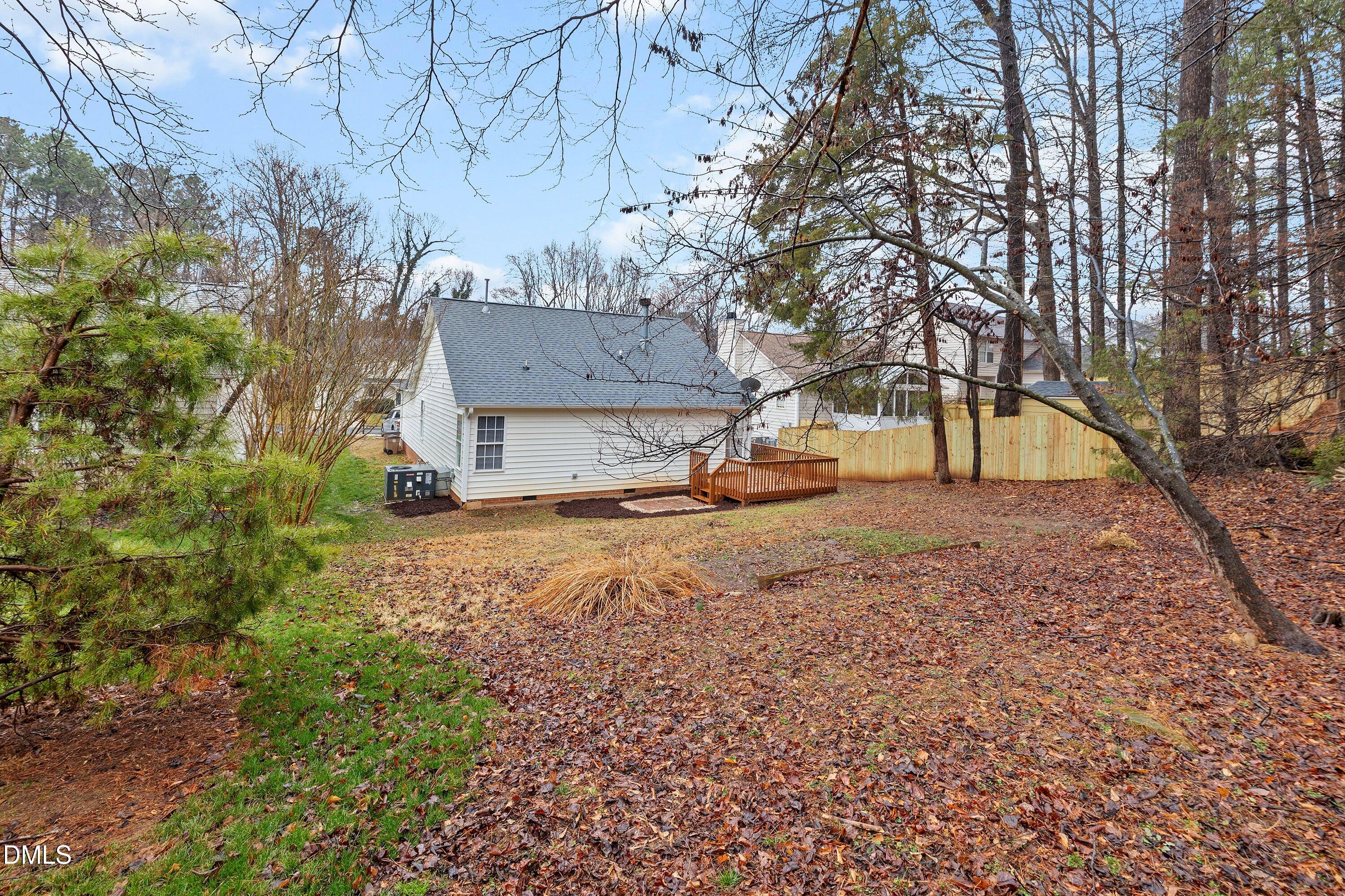 140 Melksham Road Wake Forest, NC 27587 - Photo 3 of 34 a view of a backyard with large trees