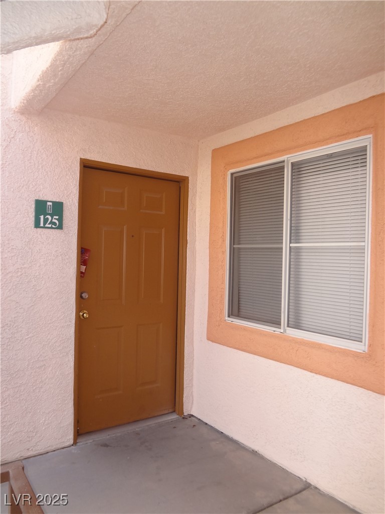 Property entrance with stucco siding