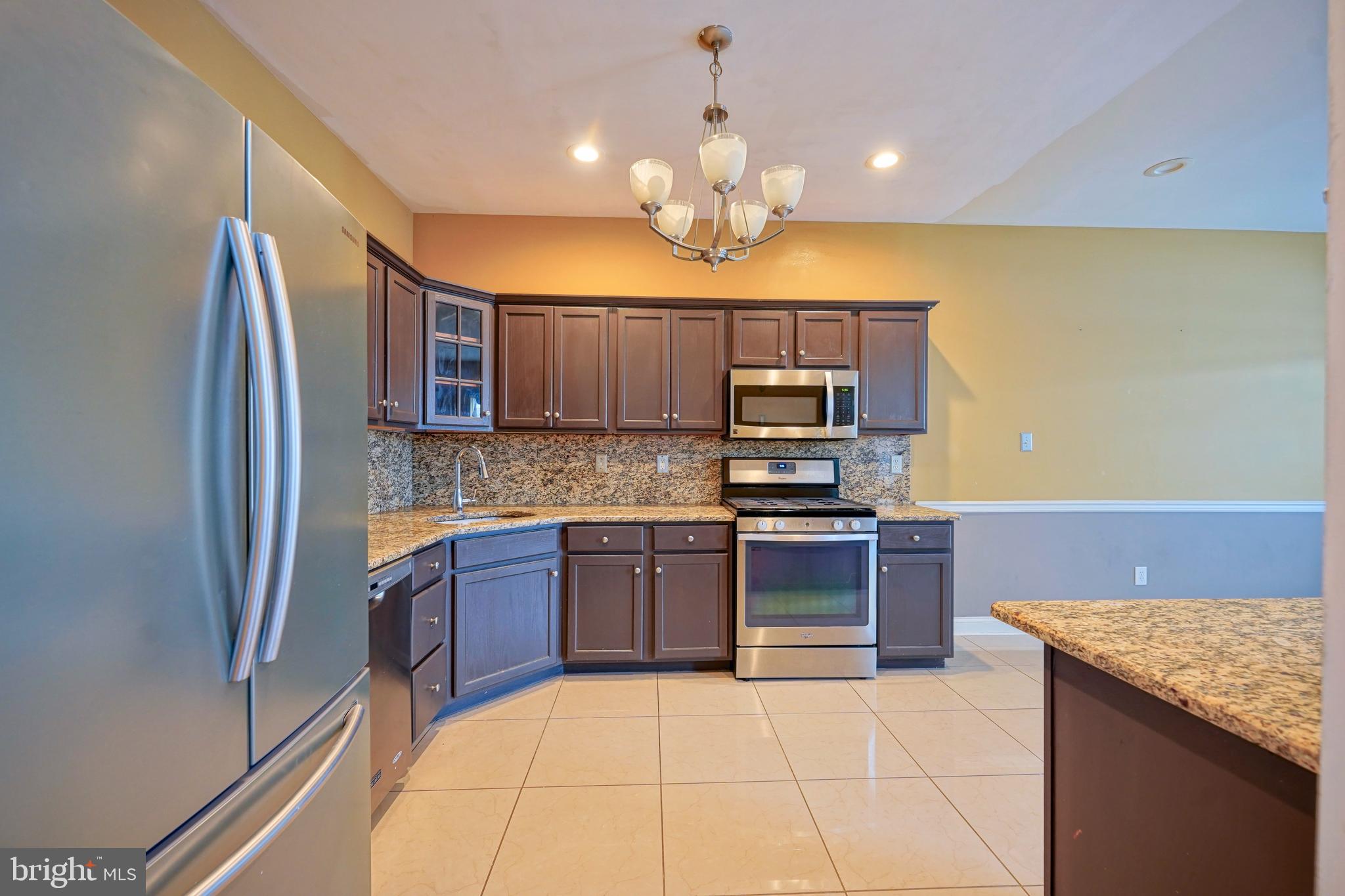 8 Bryce Road Berlin, NJ 08009 - Photo 12 of 36 a kitchen with stainless steel appliances granite countertop a refrigerator and a stove top oven