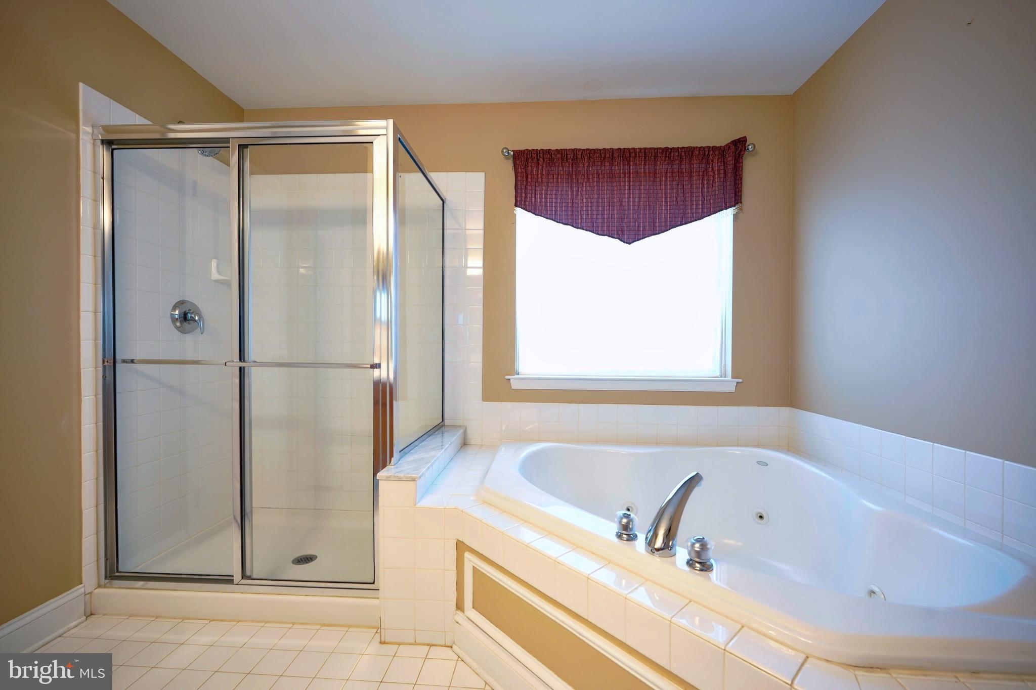 8 Bryce Road Berlin, NJ 08009 - Photo 23 of 36 a bathroom with a bathtub and a shower