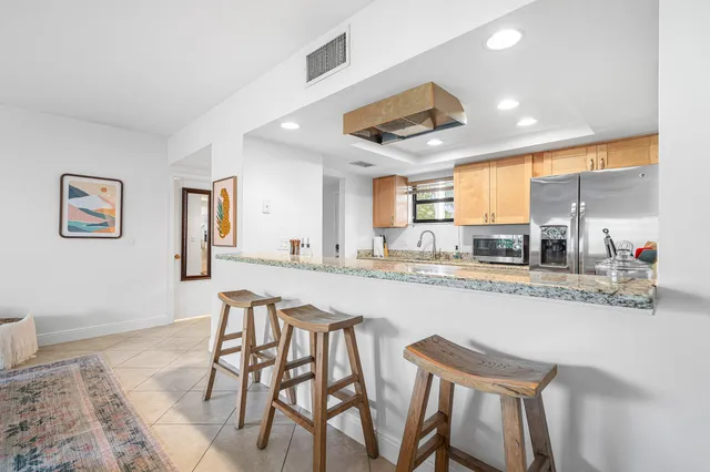 a large kitchen with a table and chairs in it