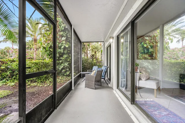 a very nice looking room with a large window and furniture