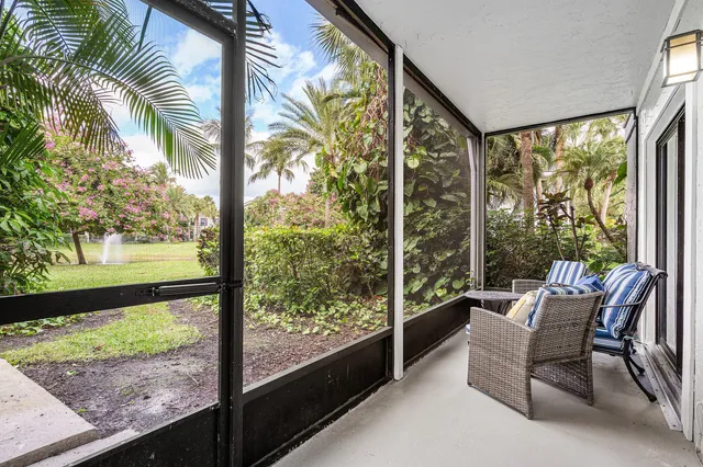 a view of a room with a large window and a bench