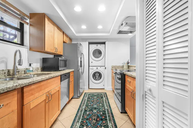 a kitchen with stainless steel appliances granite countertop a sink and cabinets