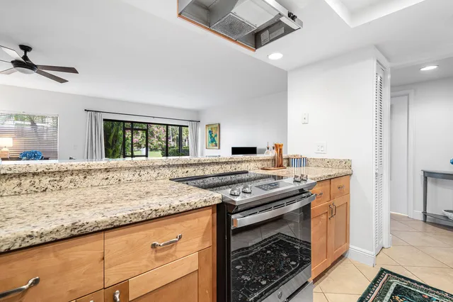 a kitchen with granite countertop a stove and a sink