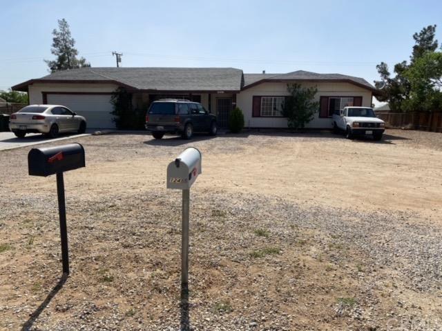 12436 Tesuque Road Apple Valley, CA 92308 - Photo 1 of 1 a front view of a house with cars parked