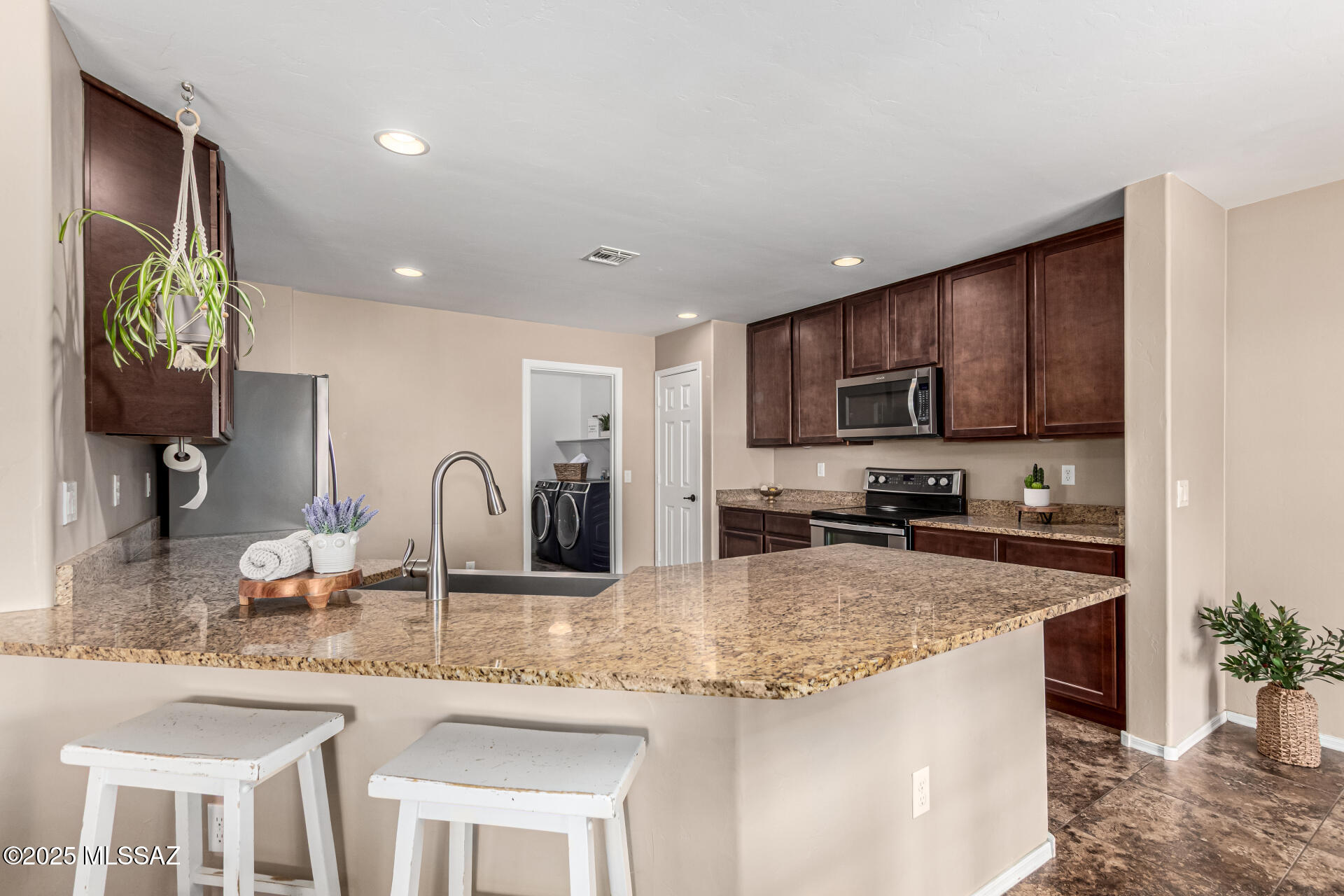 9528 Desert Fauna Loop Tucson, AZ 85747 - Photo 12 of 46 a kitchen with granite countertop a sink and counter space