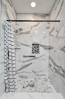 a bathroom with a shower and a sink