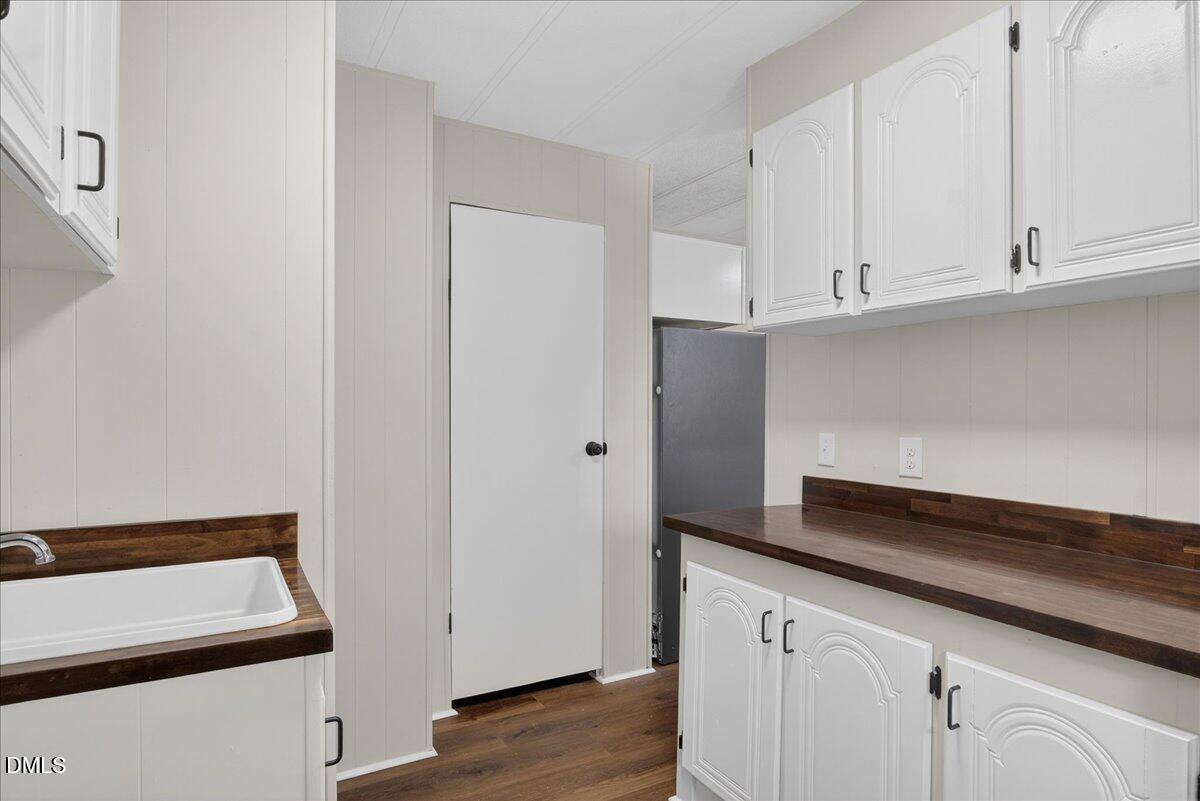 2428 Sims Bridge Road Kittrell, NC 27544 - Photo 16 of 57 a kitchen with granite countertop white cabinets and white appliances