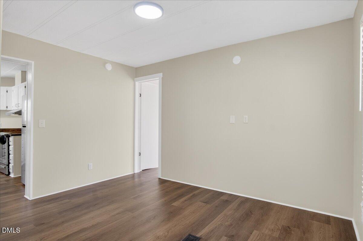 2428 Sims Bridge Road Kittrell, NC 27544 - Photo 19 of 57 a view of an empty room with wooden floor