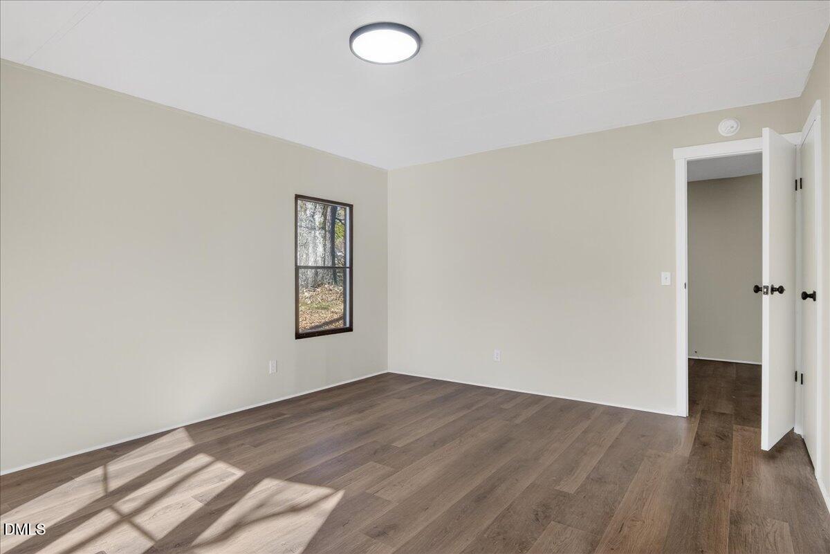 2428 Sims Bridge Road Kittrell, NC 27544 - Photo 22 of 57 an empty room with wooden floor and closet